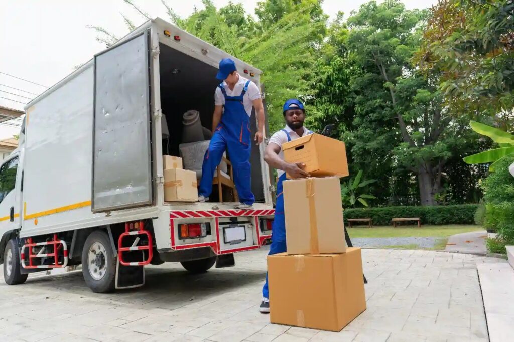 Efficient movers carefully loading household items into a moving truck.